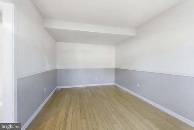 a view of a room with wooden floor