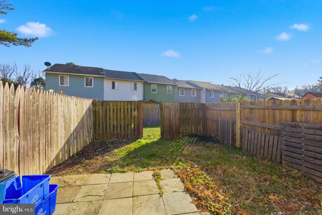 a view of a wooden fence next to a yard