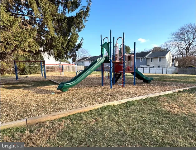 a view of a park with swings and slides