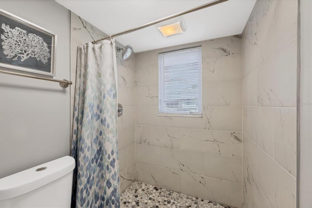 331 Bocilla Drive Boca Grande, FL 33921 - Photo 20 of 34 a bathroom with a shower curtain and a toilet