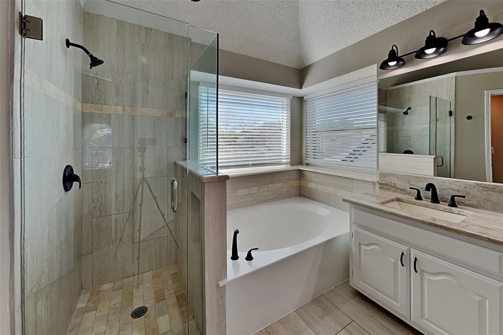 1008 Timberline Lane Allen, TX 75002 - Photo 12 of 25 a bathroom with a granite countertop sink a toilet and shower