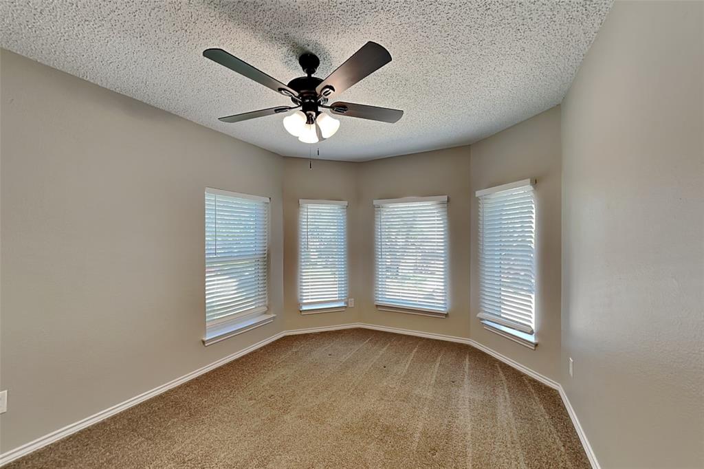 1008 Timberline Lane Allen, TX 75002 - Photo 17 of 25 an empty room with windows and ceiling fan