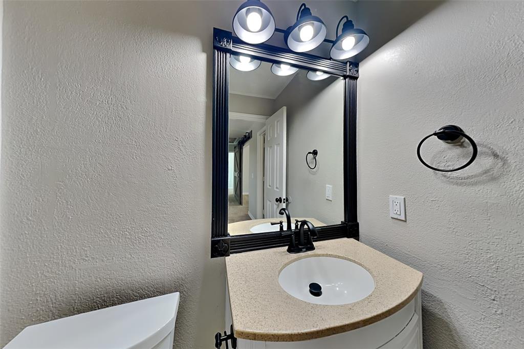 1008 Timberline Lane Allen, TX 75002 - Photo 18 of 25 a bathroom with a sink and a mirror