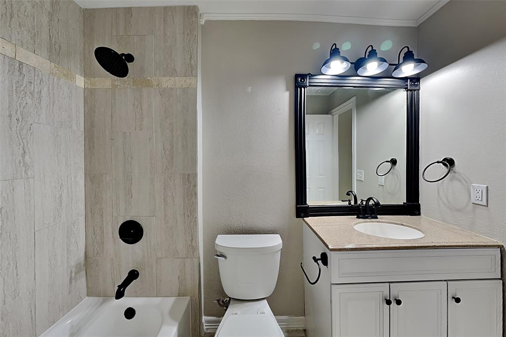 1008 Timberline Lane Allen, TX 75002 - Photo 20 of 25 a bathroom with a sink a toilet a mirror a vanity and shower