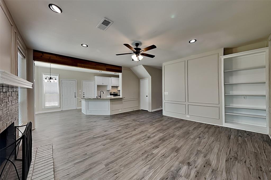 1008 Timberline Lane Allen, TX 75002 - Photo 2 of 25 a view of an empty room with a window and wooden floor