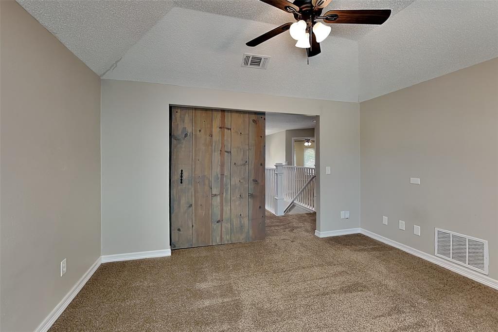 1008 Timberline Lane Allen, TX 75002 - Photo 21 of 25 an empty room with chandelier fan