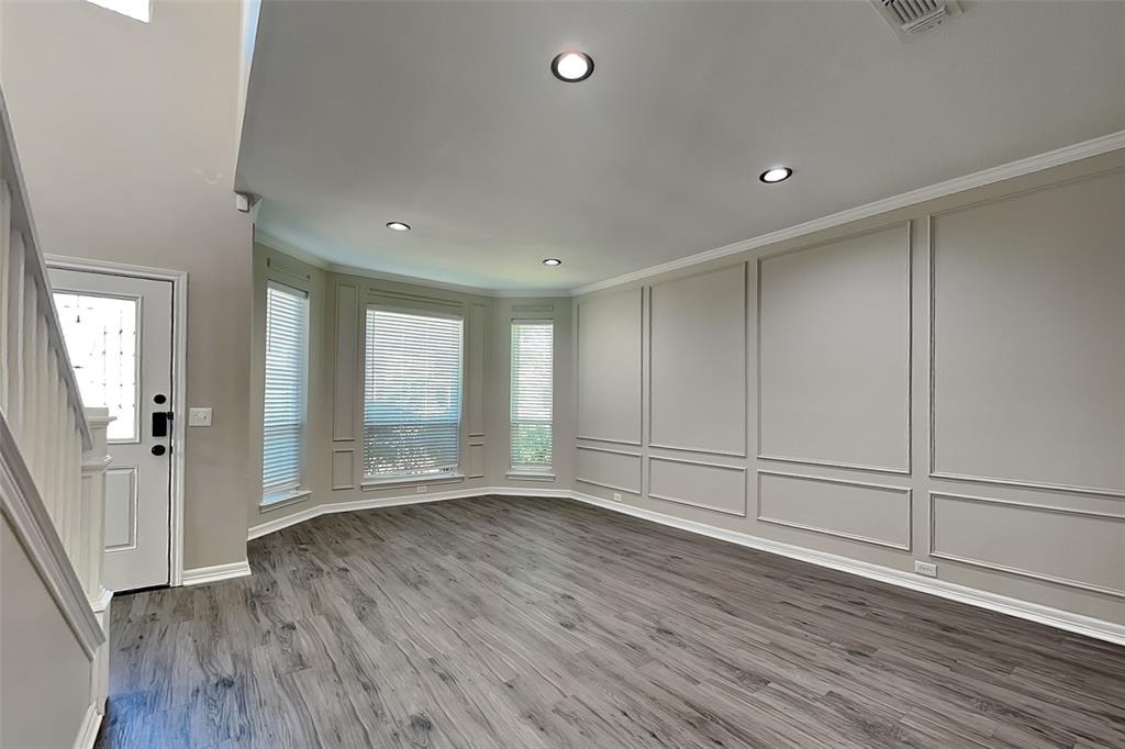 1008 Timberline Lane Allen, TX 75002 - Photo 4 of 25 an empty room with wooden floor and windows