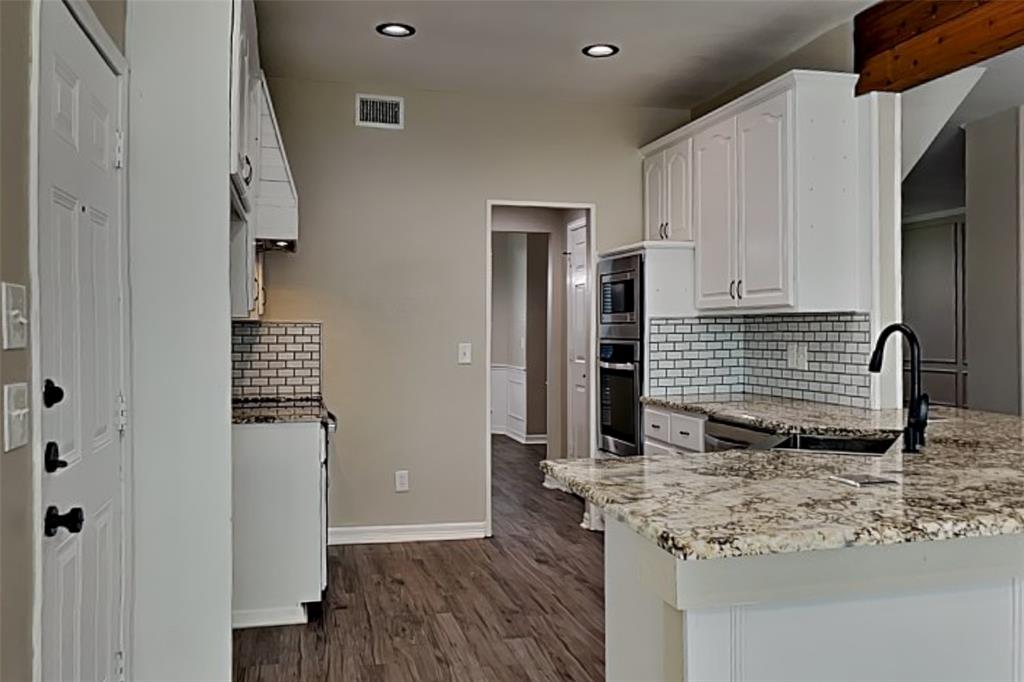 1008 Timberline Lane Allen, TX 75002 - Photo 6 of 25 a view of living room with cabinets and wooden floor