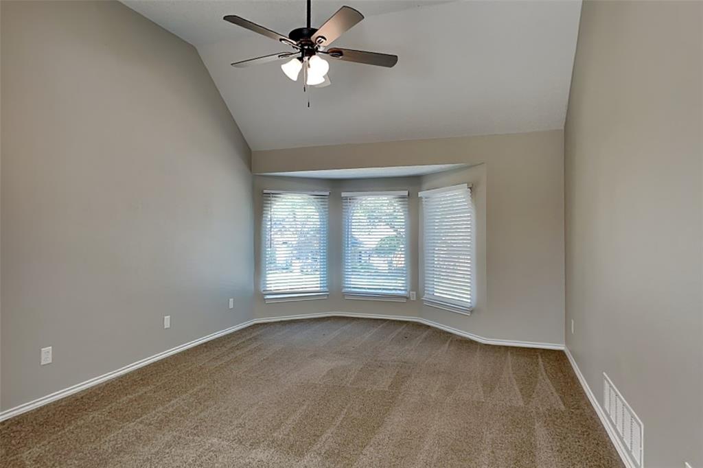 1008 Timberline Lane Allen, TX 75002 - Photo 10 of 25 an empty room with chandelier fan and windows