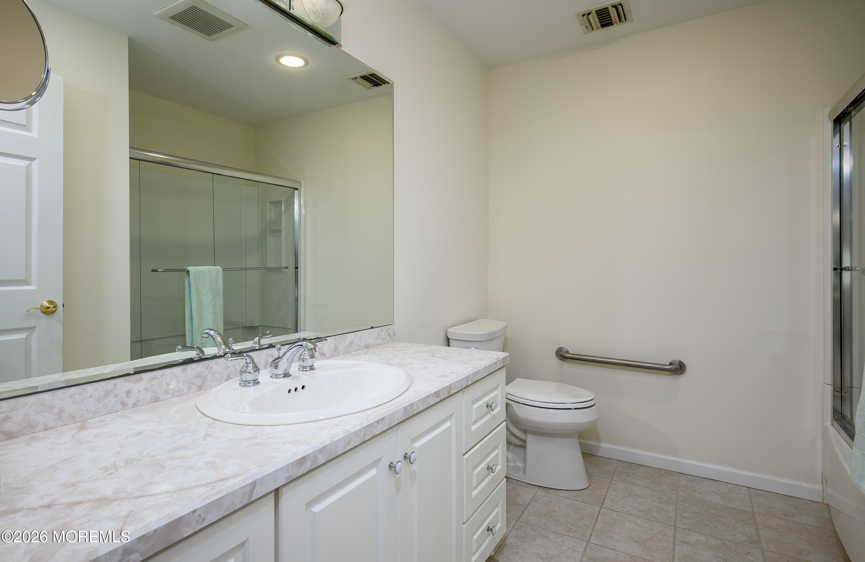 805 Front Street Union Beach, NJ 07735 - Photo 27 of 65 a bathroom with a granite countertop sink a toilet and a mirror