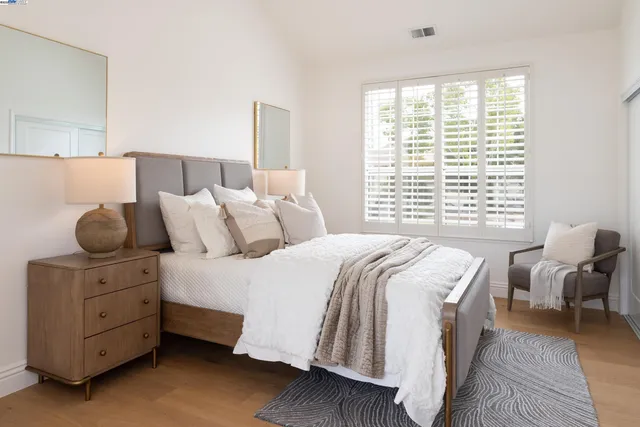 a kitchen with stainless steel appliances granite countertop a white cabinets and wooden floor