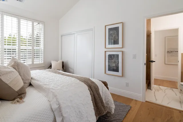 a kitchen with stainless steel appliances granite countertop a stove a refrigerator and a white cabinets