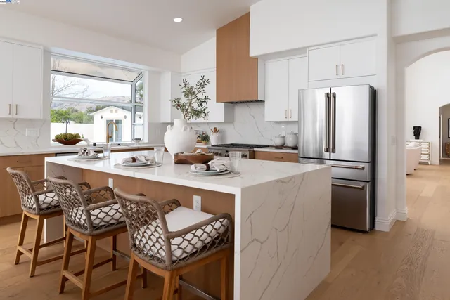 a living room with furniture a fireplace and a large mirror