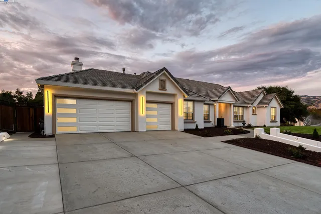 a view of a house with a large space and a car parked in front of it