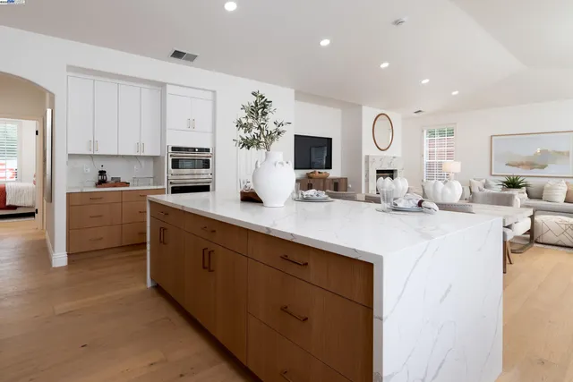 a bedroom with furniture and a large window