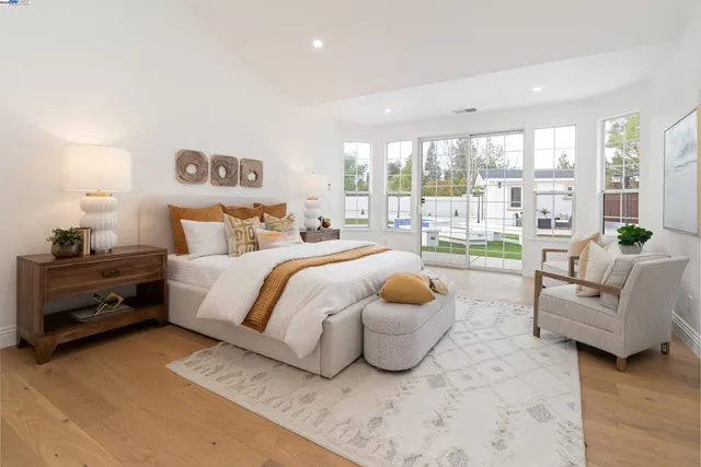 a bedroom with two beds and a window