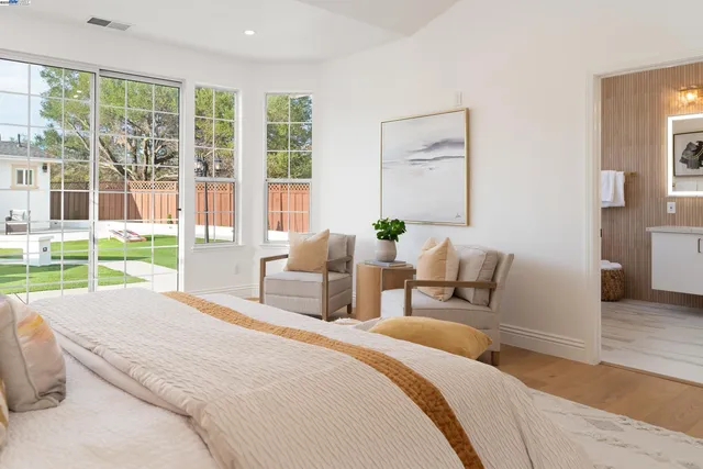 a bedroom with a bed a lamp and a window