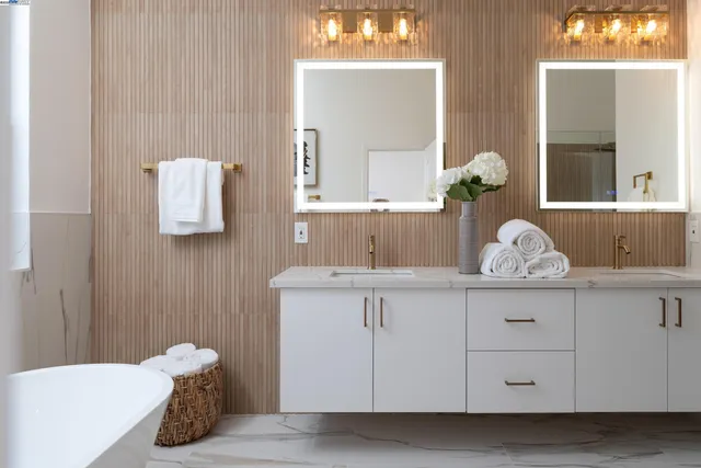 a view of a patio with a dining table and chairs with an umbrella