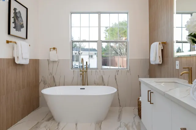 a kitchen with a table chairs a stove and a microwave