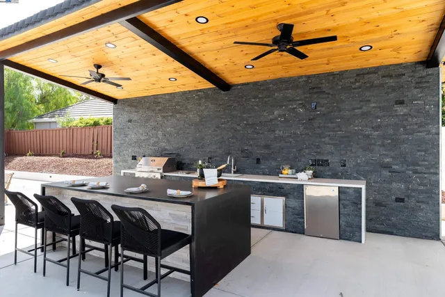 a view of a swimming pool with lounge chairs in patio