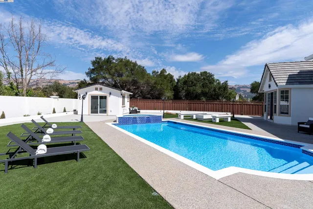 a view of a patio with a table and chairs