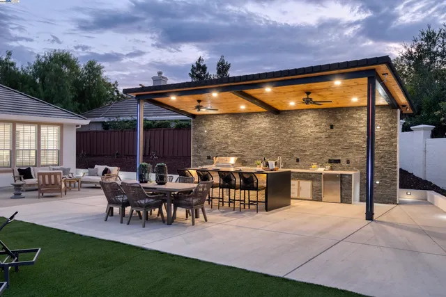 a living room with furniture a large window and a fireplace
