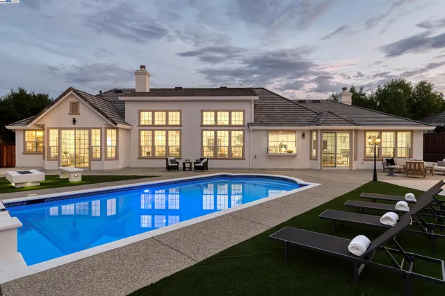 a living room with furniture a table and a fireplace