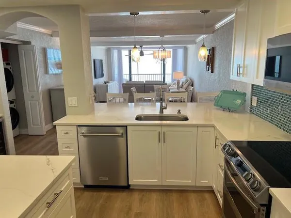 a kitchen with a sink stove and refrigerator