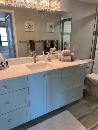 a bathroom with a double vanity sink and mirror