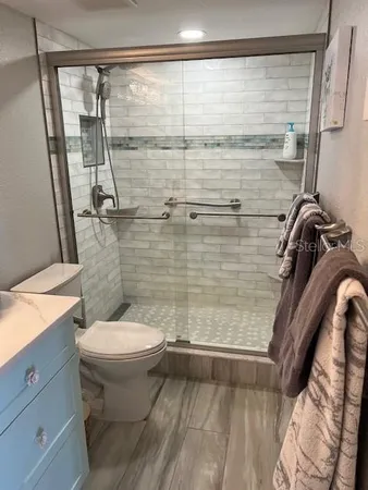 a bathroom with a toilet and a shower
