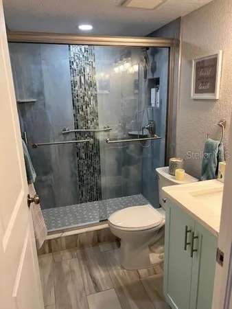 a bathroom with a sink toilet and shower