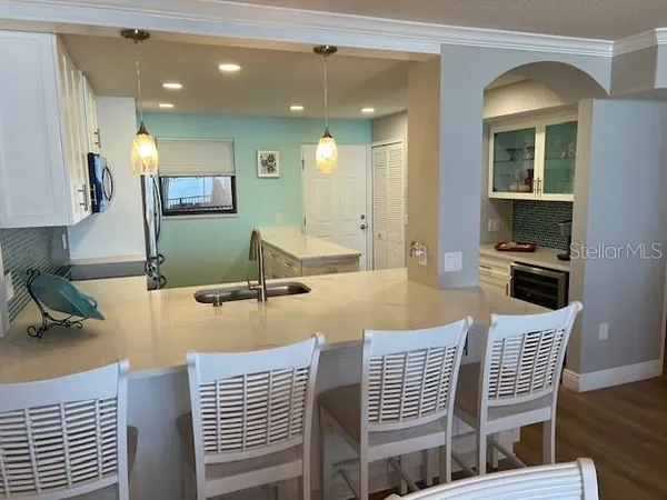 a dining room with furniture and a wooden floor