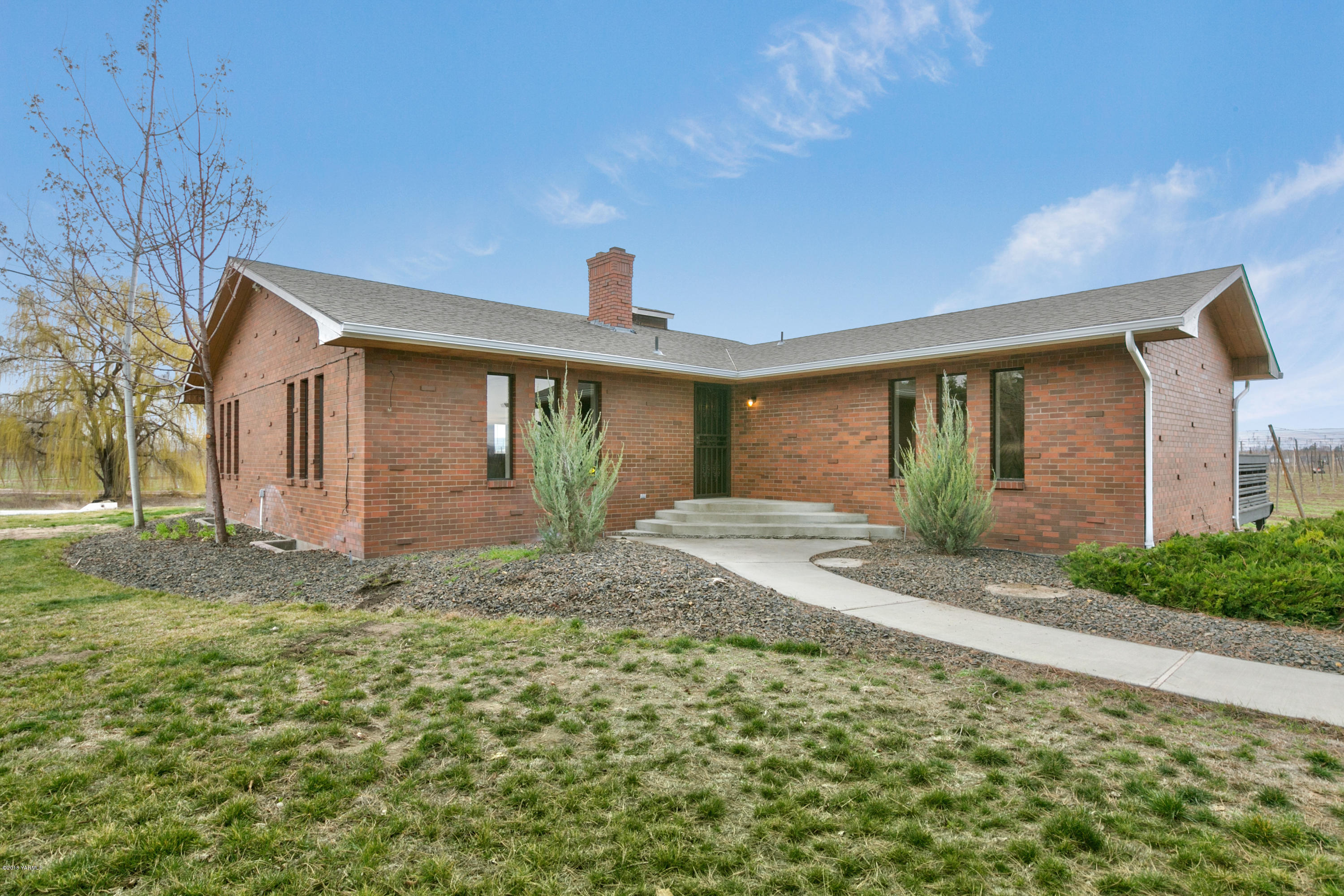 1004 Birchfield Road Yakima, WA 98901 - Photo 1 of 23 a front view of a house with garden