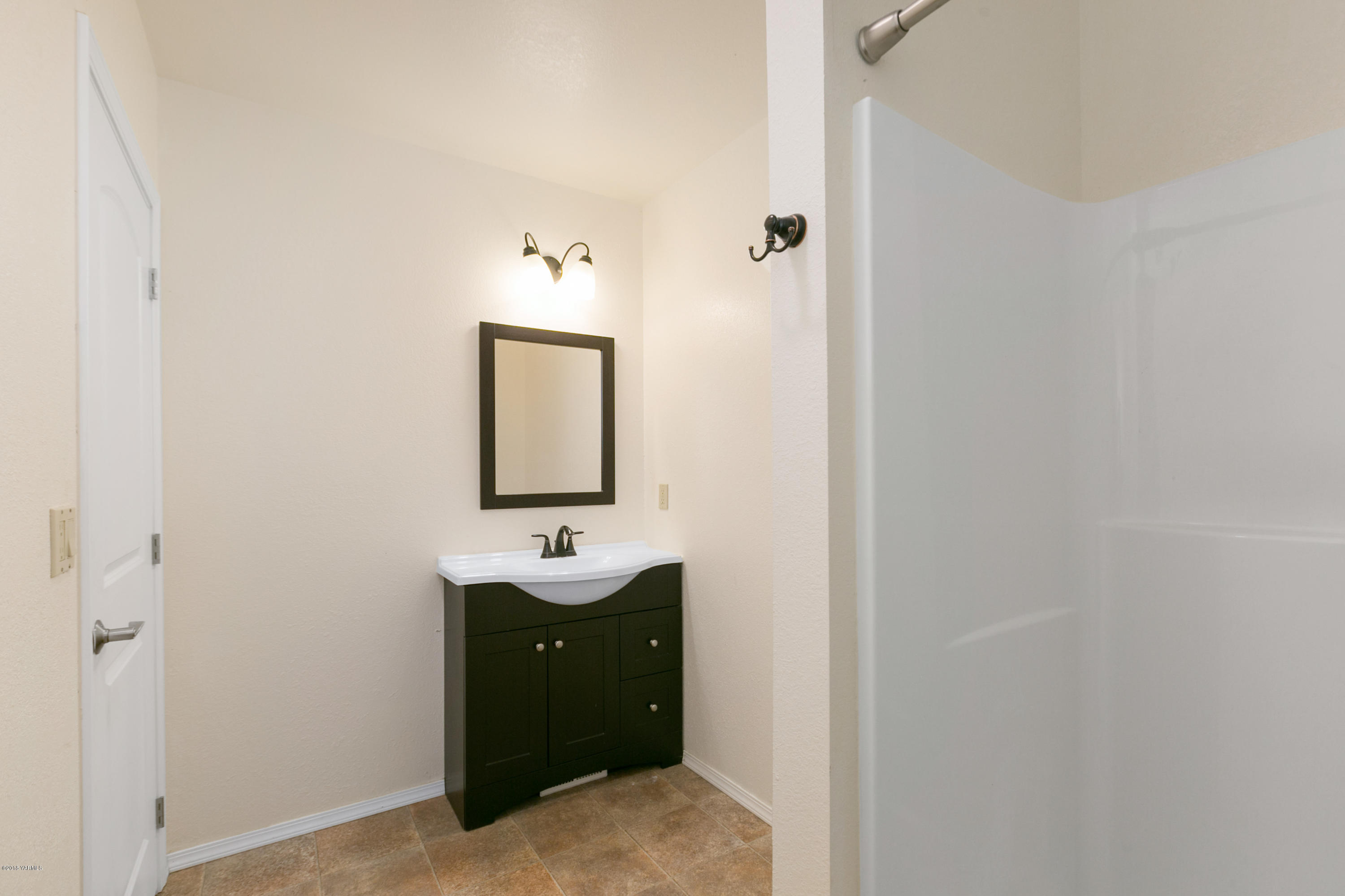 1004 Birchfield Road Yakima, WA 98901 - Photo 16 of 23 a bathroom with a toilet sink and mirror