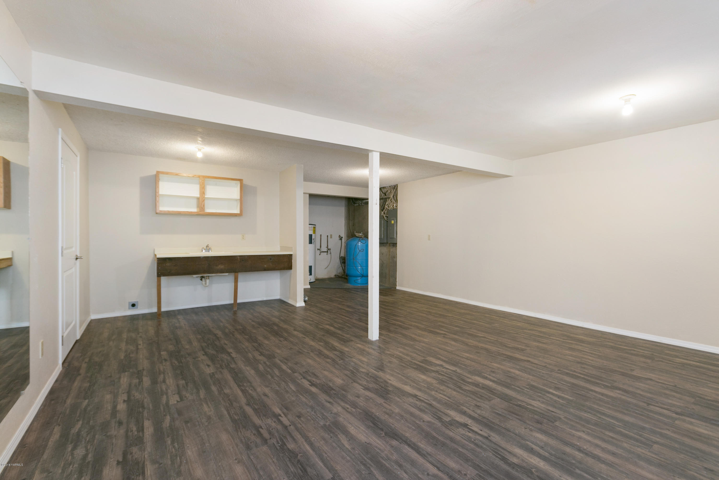 1004 Birchfield Road Yakima, WA 98901 - Photo 22 of 23 a view of an empty room with wooden floor and a window