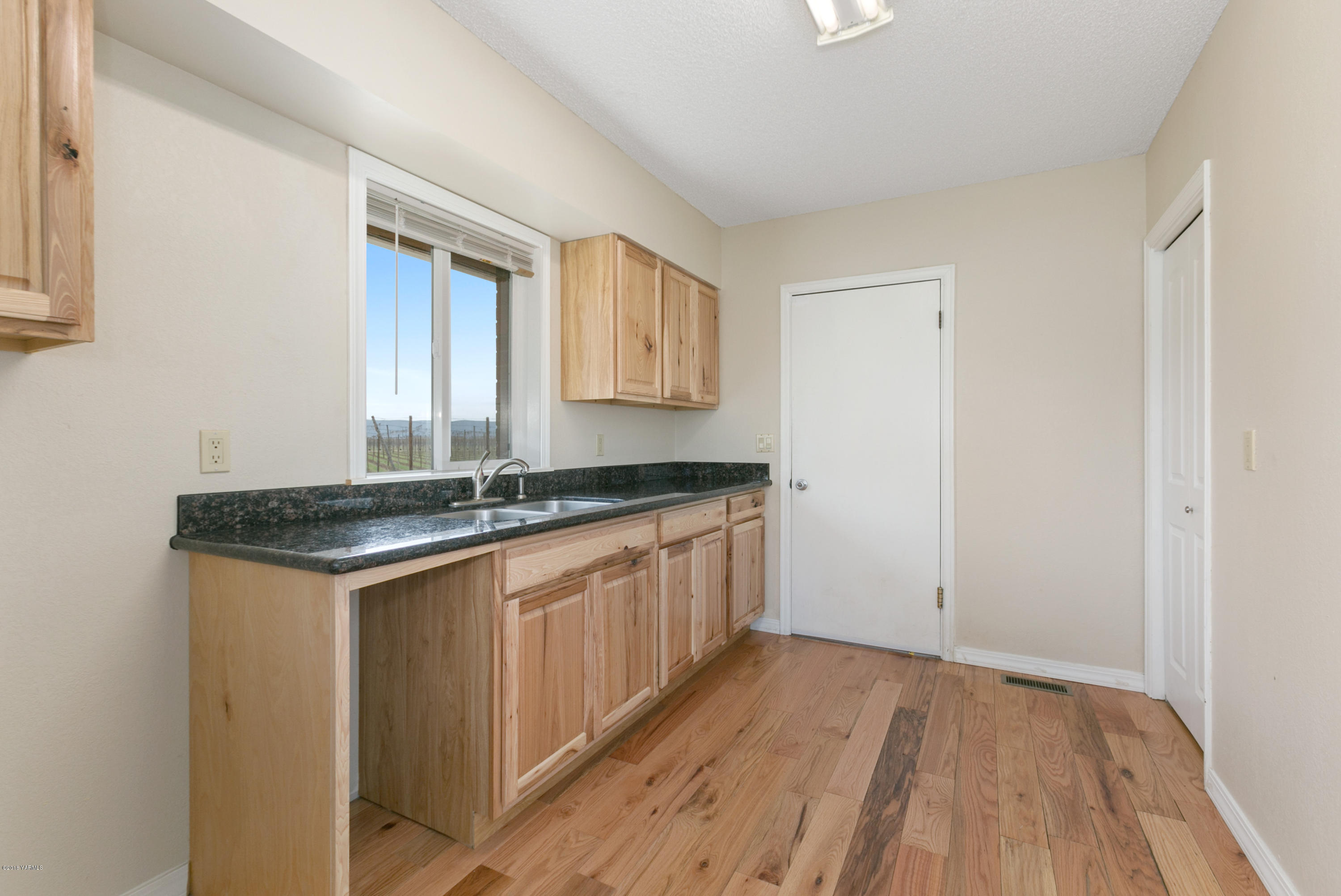 1004 Birchfield Road Yakima, WA 98901 - Photo 23 of 23 a kitchen with a sink stove and cabinets