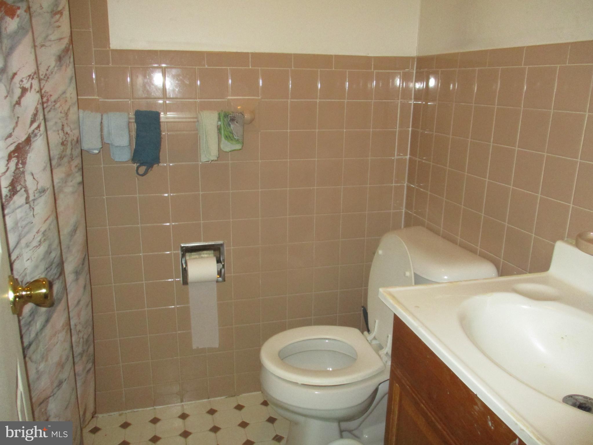 122 Hewitt Street Trenton, NJ 08611 - Photo 9 of 15 a bathroom with a sink a toilet and shower
