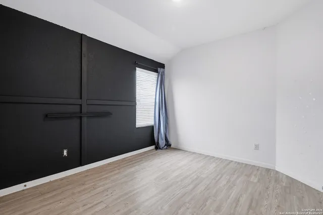 an empty room with wooden floor