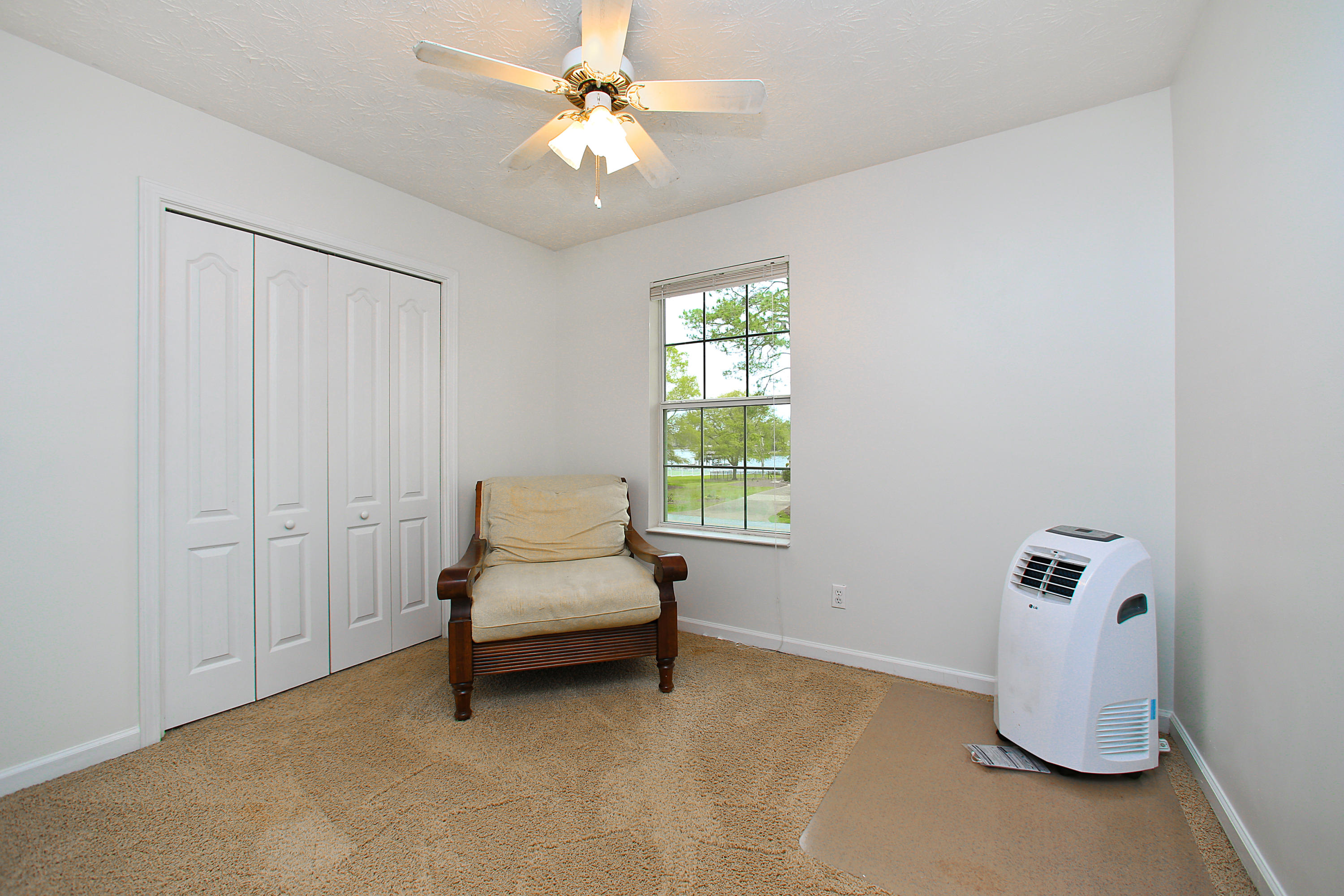 781 Bay Grove Road Freeport, FL 32439 - Photo 13 of 19 a spacious bedroom with a bed and a chandelier