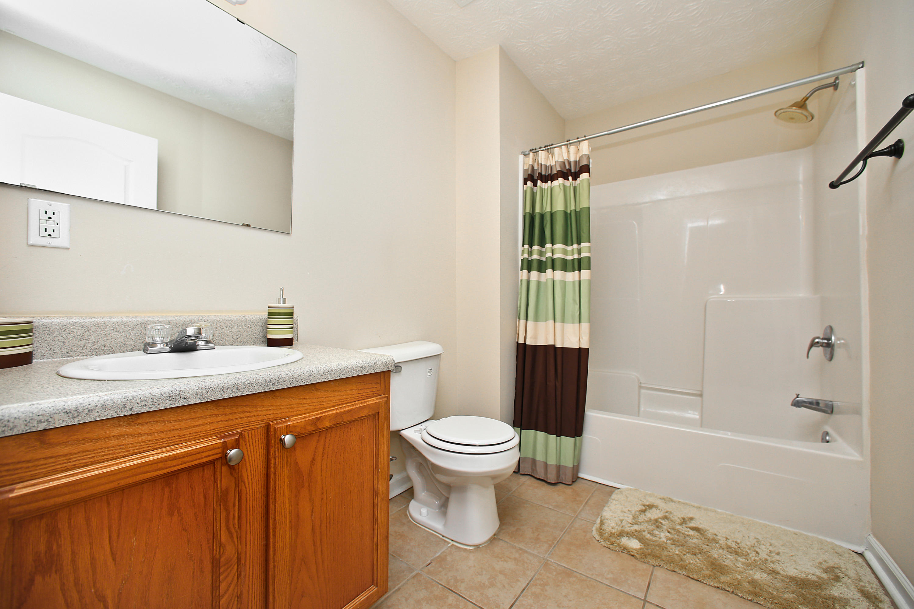 781 Bay Grove Road Freeport, FL 32439 - Photo 14 of 19 a bathroom with a granite countertop sink a toilet and shower