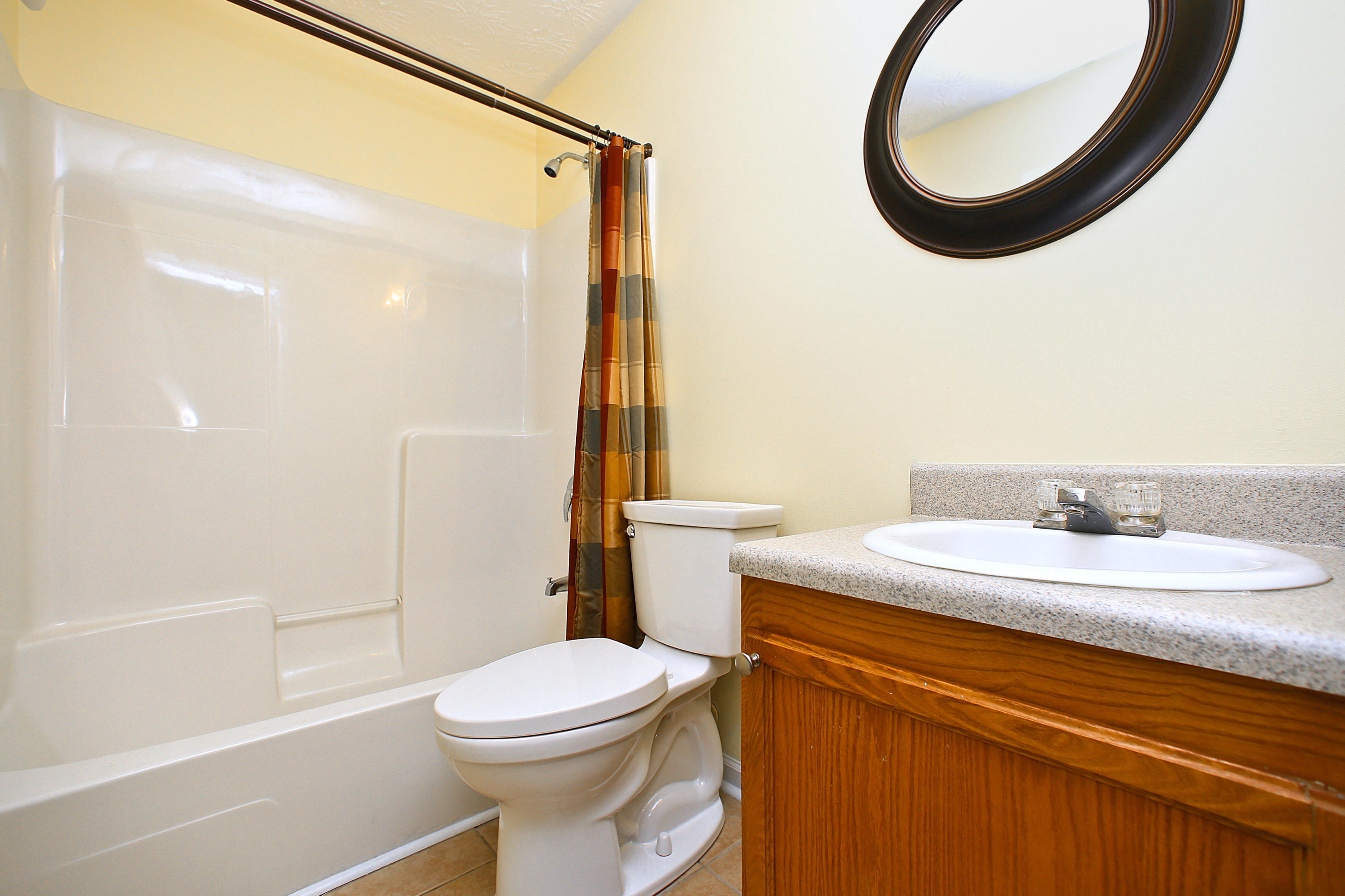 781 Bay Grove Road Freeport, FL 32439 - Photo 16 of 19 a bathroom with a granite countertop sink mirror vanity and toilet