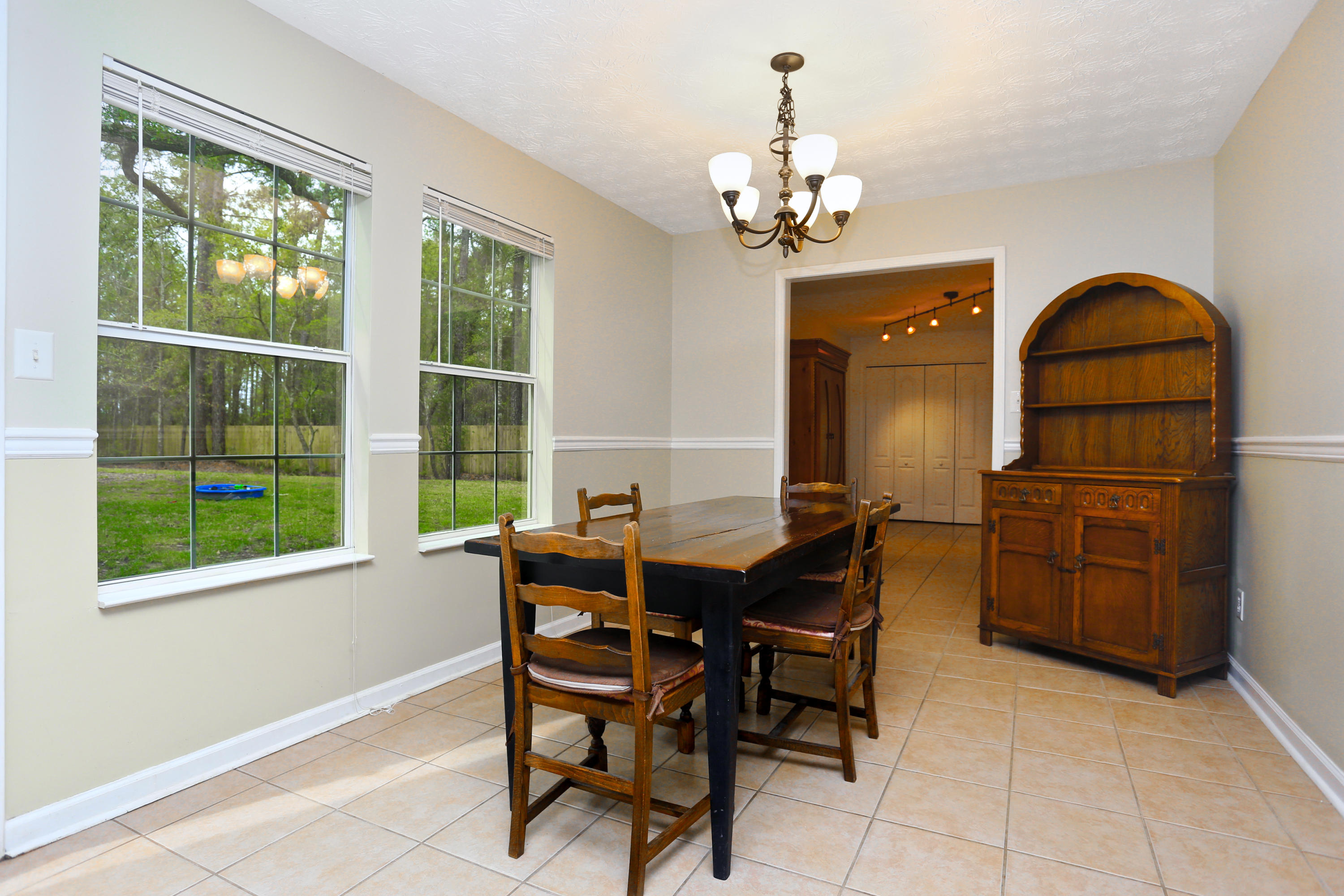 781 Bay Grove Road Freeport, FL 32439 - Photo 5 of 19 a dining room with furniture a chandelier and wooden floor