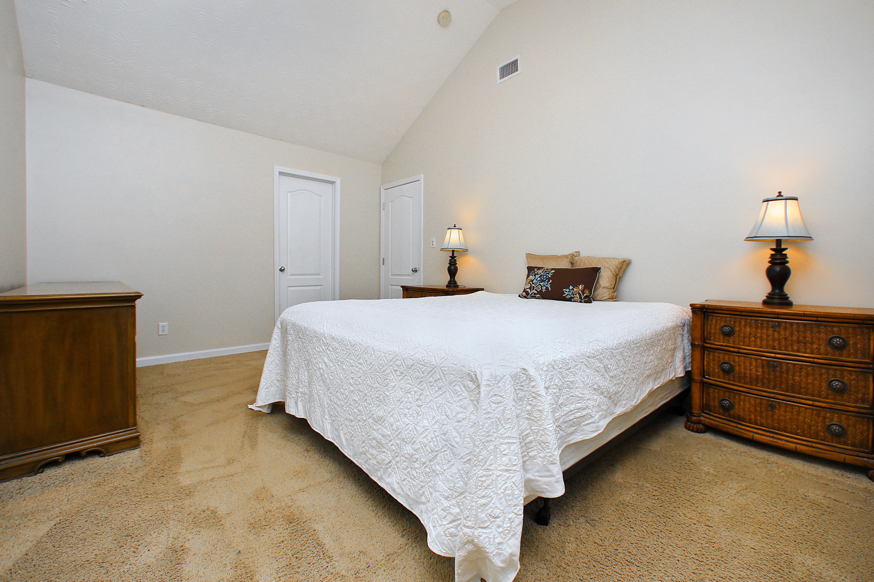 781 Bay Grove Road Freeport, FL 32439 - Photo 8 of 19 a bedroom with a bed and a lamp on dresser
