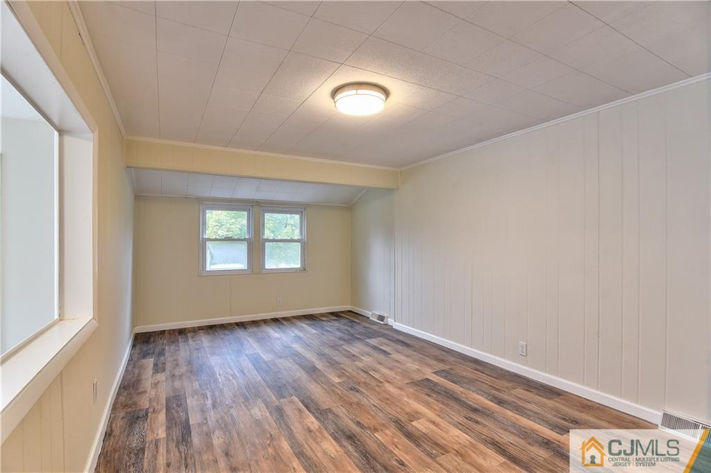 113 Stony Road Edison, NJ 08817 - Photo 12 of 20 wooden floor in an empty room with a window