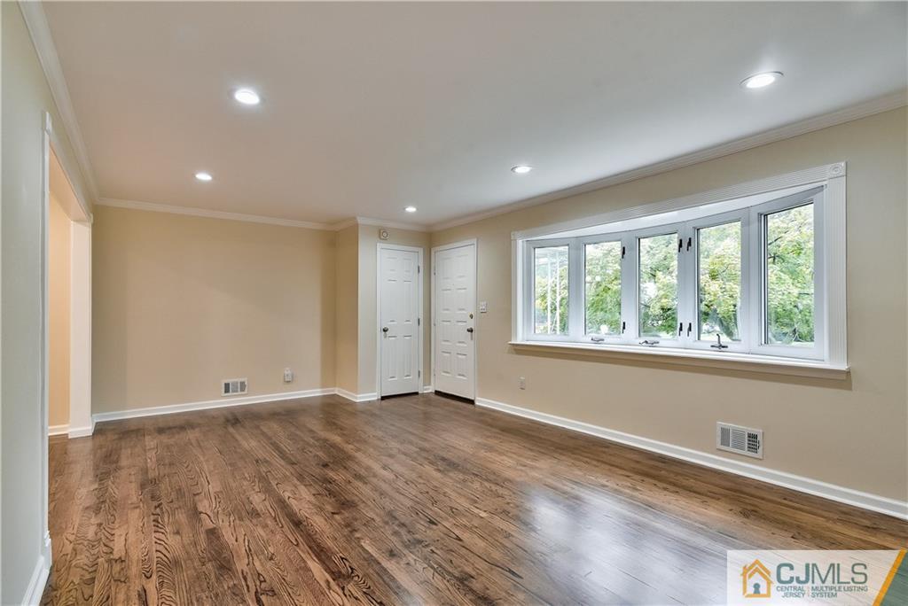 113 Stony Road Edison, NJ 08817 - Photo 3 of 20 an empty room with wooden floor and windows