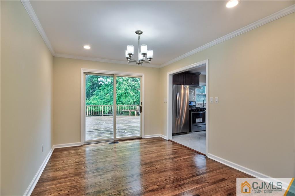 113 Stony Road Edison, NJ 08817 - Photo 5 of 20 wooden floor in an empty room with a window