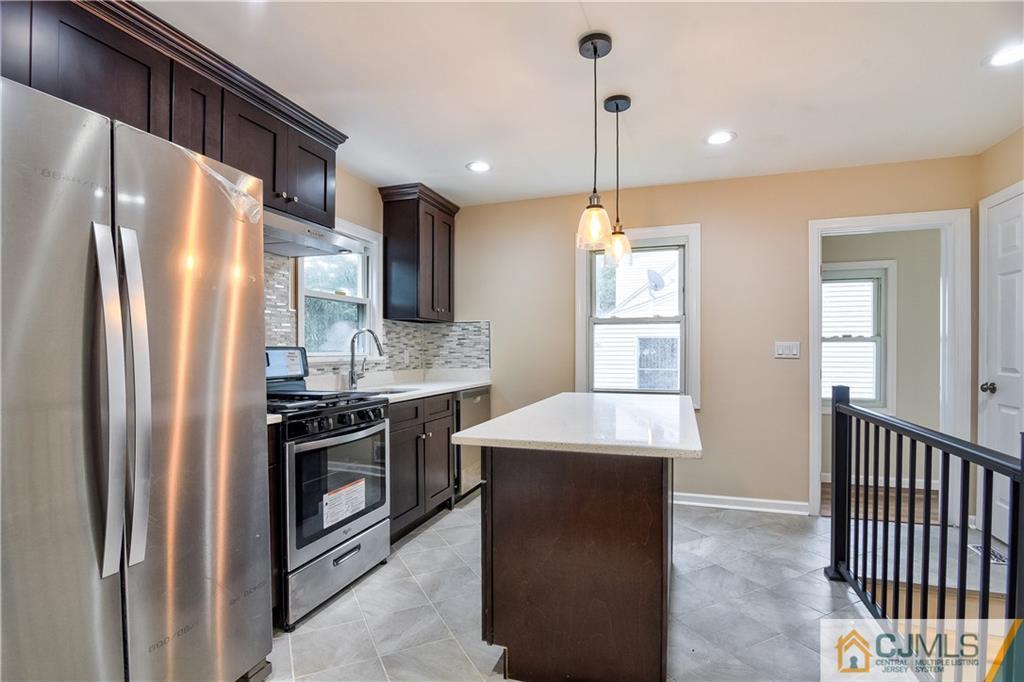 113 Stony Road Edison, NJ 08817 - Photo 6 of 20 a kitchen with stainless steel appliances granite countertop a refrigerator a sink a stove and a wooden floors