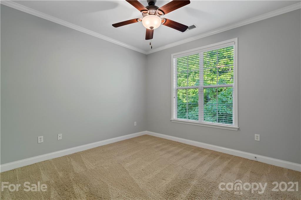 8929 Rosalyn Glen Road, Unit 108 Cornelius, NC 28031 - Photo 13 of 28 a view of a room with windows and ceiling fan