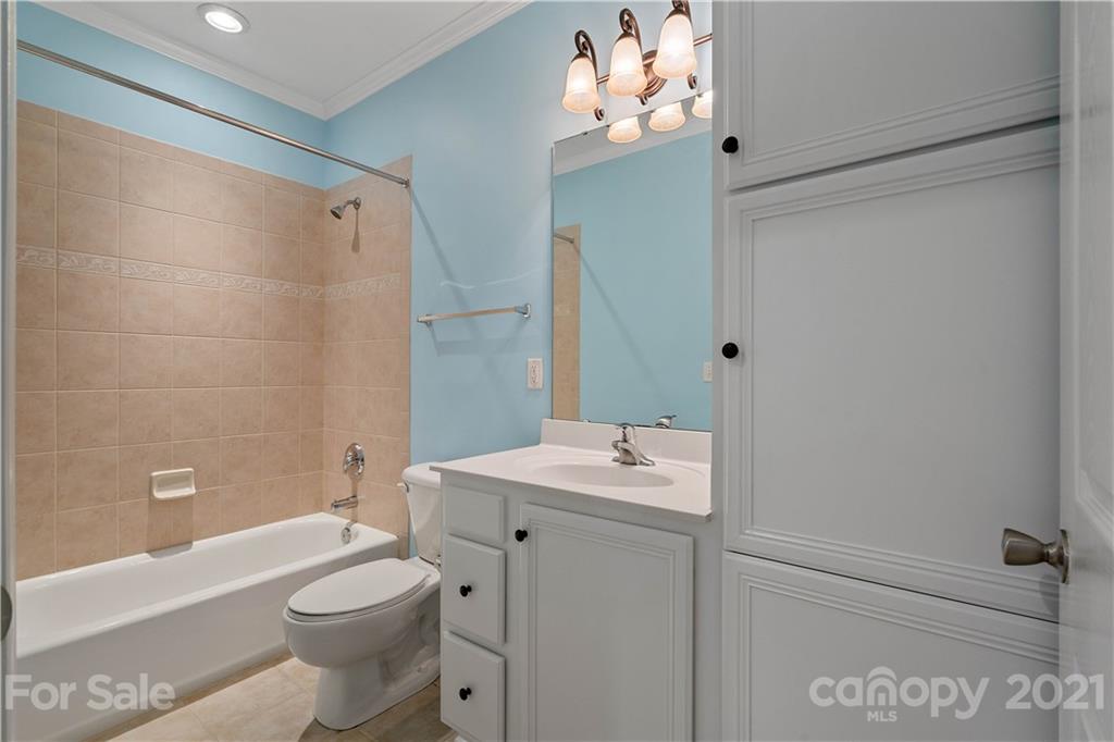 8929 Rosalyn Glen Road, Unit 108 Cornelius, NC 28031 - Photo 16 of 28 a bathroom with a sink a toilet and shower