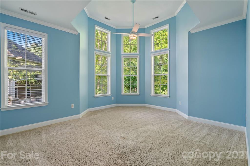 8929 Rosalyn Glen Road, Unit 108 Cornelius, NC 28031 - Photo 20 of 28 a view of an empty room with a window and chandelier